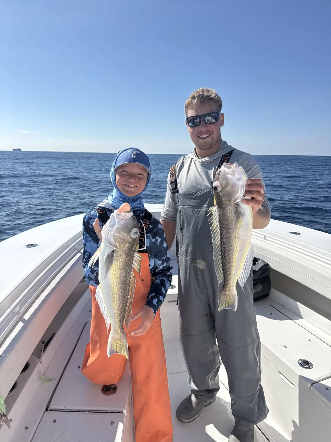 Two anglers holding tilefish after offshore bottom fishing