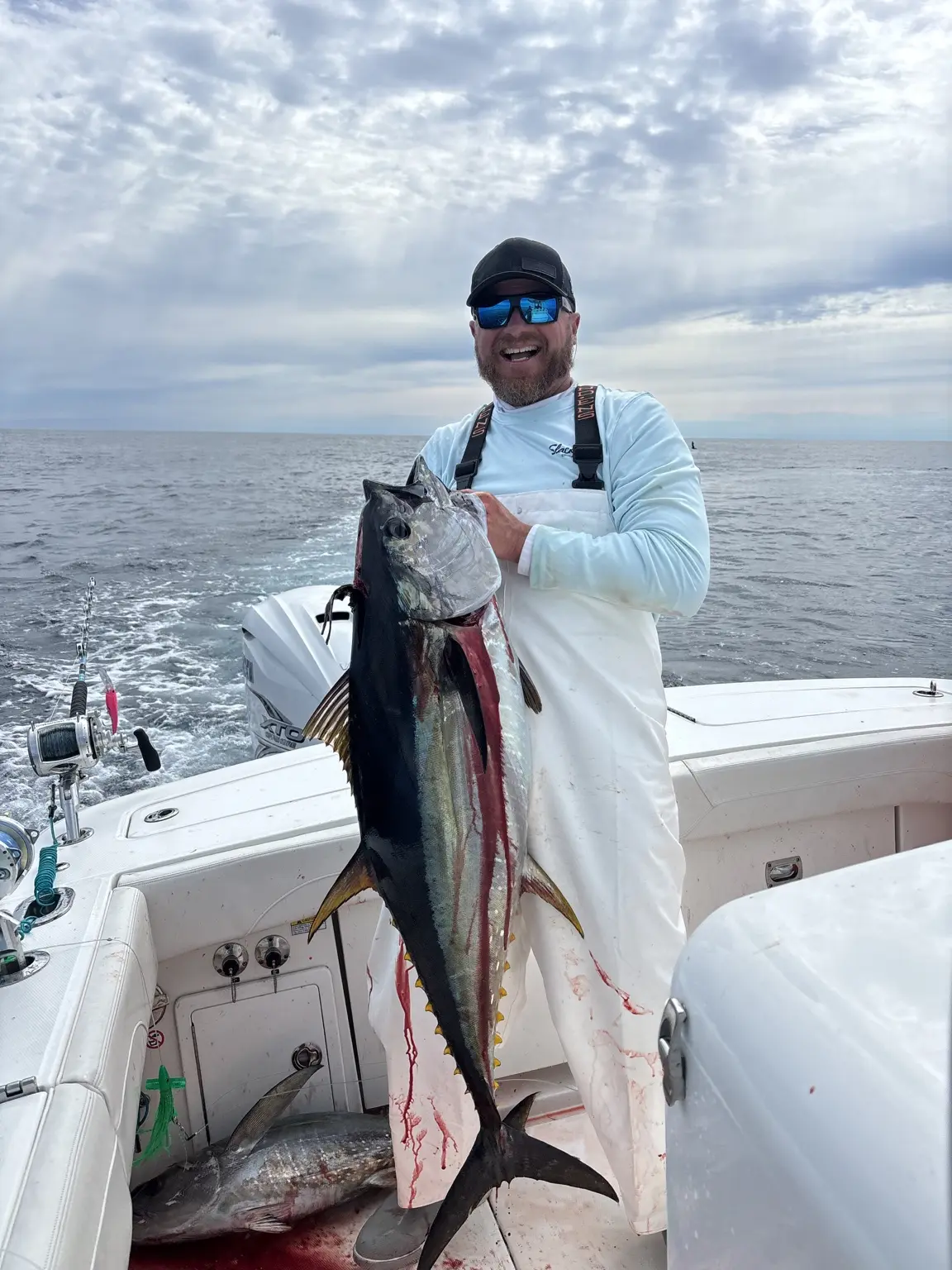 Angler holding a large yellowfin tuna on the canyon grounds