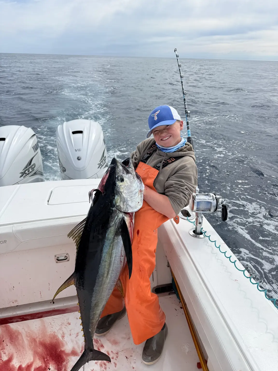 Young angler smiling with a canyon yellowfin tuna