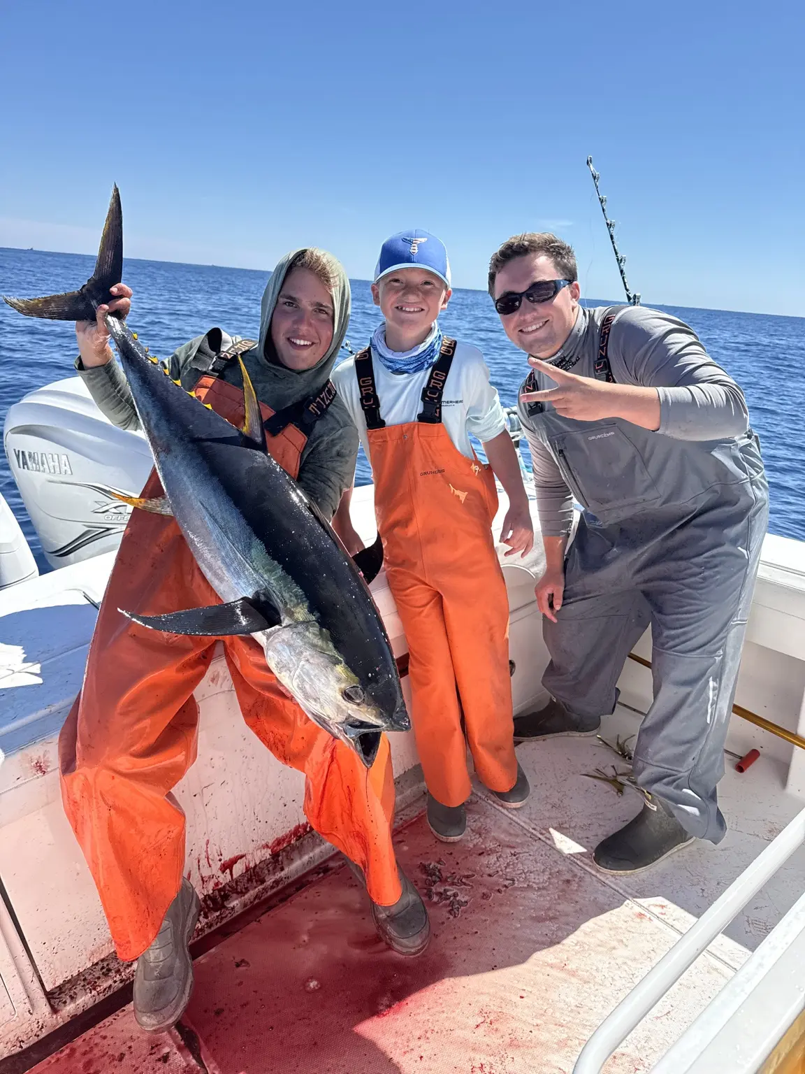 Fishing crew celebrating a large yellowfin tuna catch
